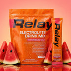 variant:49281673265389 Orange Relay Electrolyte Drink Mix package with watermelon slices on a light background